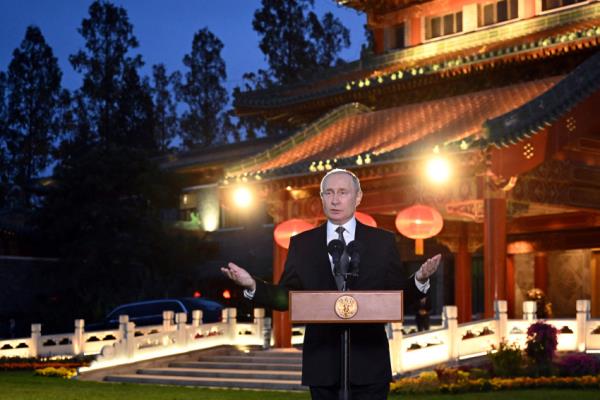 Russian President Putin attends a press conference in Beijing