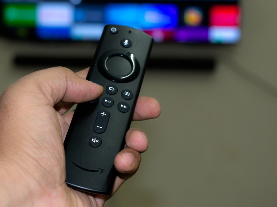 Amazon fire stick TV remote in hand